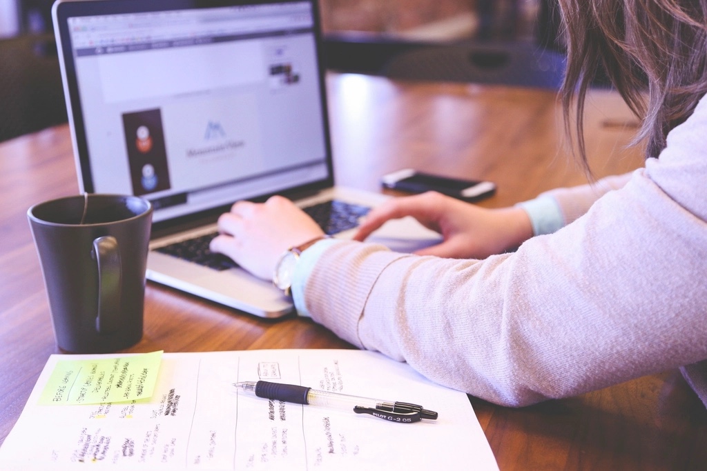 A focused entrepreneur using a laptop to manage their AI tool stack